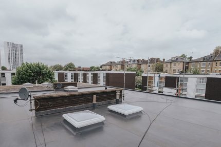 New skylights integrated into a seamless flat roof to provide natural interior lighting.