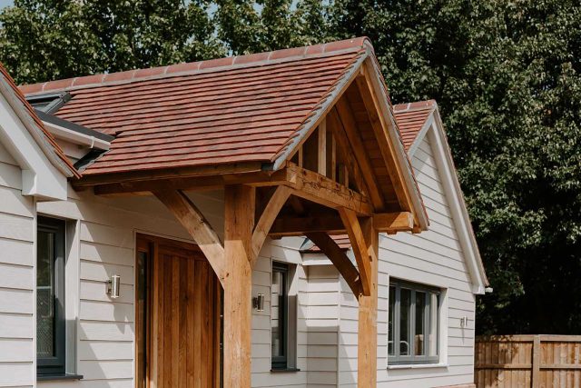 Newly constructed pitched roof featuring traditional clay plain tiles for a new build project in Surrey.
