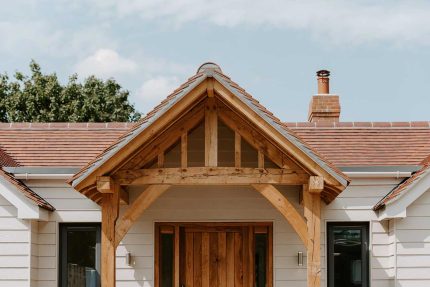 Seamless Garland flat felt roofing system installed alongside new timber cladding on a Surrey new build.