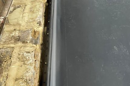 Close-up of a seamless, waterproof Garland flat felt roofing membrane installed on a South West London home.