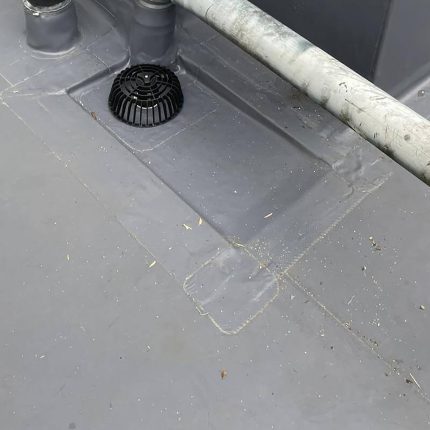 Precision welded flat roof drainage grate detailing demonstrating the structural capacity and expertise of our commercial flat roofer Chelsea team.