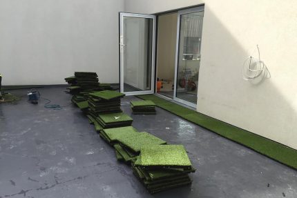Visually appealing flat roof finished with Castle Composites astroturf matting and new safety railings.