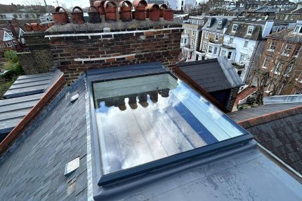 Traditional natural slate roofing and custom leadwork installed on a pitched roof in North London.