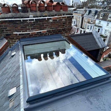 Single-ply flat roof membrane, warm roof insulation, and skylights installed by our Hampstead flat roofer.