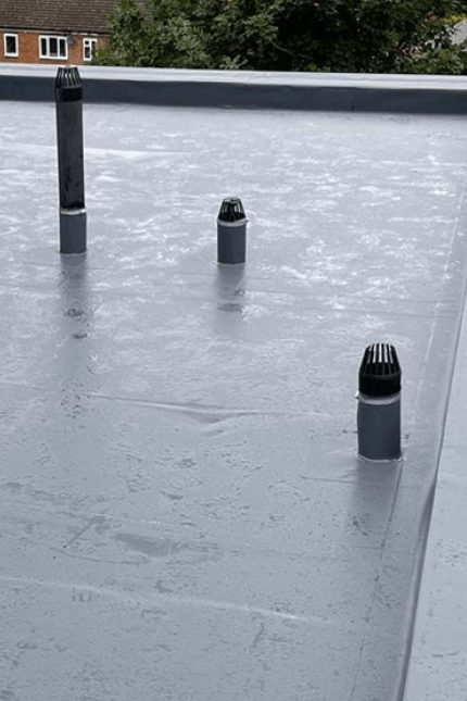 Lead Grey Sika Sarnafil single-ply flat roof membrane and perimeter detailing installed in London.