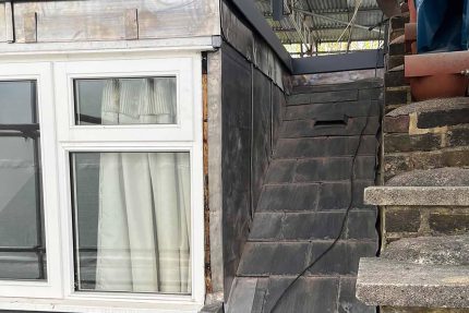 Professional roof builders securing a new flat roofing system in West Hampstead.