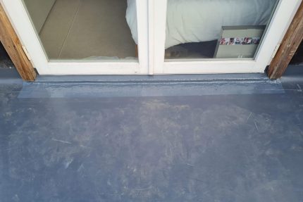 Modern flat roof installation in London featuring integrated internal outlets for efficient water drainage.