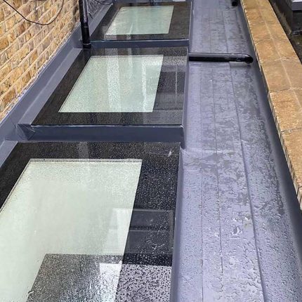 Expert application of a seamless liquid waterproofing membrane around commercial skylights executed by our experienced flat roofer london technicians.