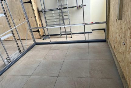 Completed Kensington roof terrace finished with elegant porcelain tiles and a new safe access hatch.