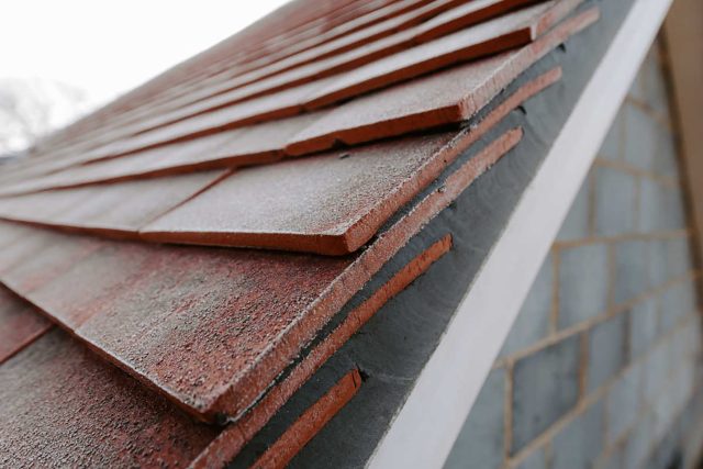 New build clay tile roof Surrey, roofing company ensures both aesthetic appeal and long-term performance, roof contractors and builders.