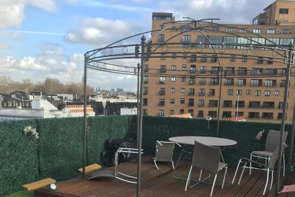 Lush artificial grass astroturf installed over a flat roof to create an inviting outdoor terrace in Knightsbridge.