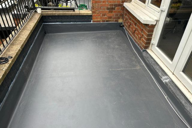Newly installed IKO Polymeric ArmourPlan single-ply flat roof on a residential property in Richmond, Surrey.