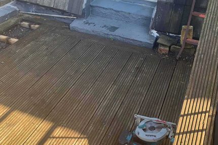 Professional roofing contractors installing a seamless and watertight SikaPlan membrane on an Ealing flat roof.