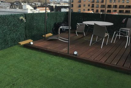 Professional flat roofing contractors installing a durable, leak-free single-ply membrane on a London rooftop.