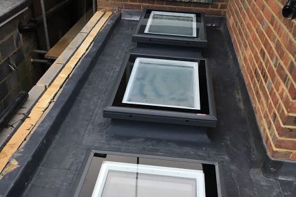 Expert West London roofers installing a durable, Sika-approved single-ply flat roof system.