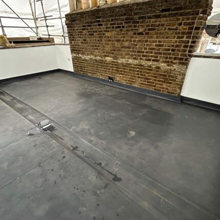 Warm flat roof membrane, stepped lead parapet flashings, and slate mansard junction installed in Mayfair W1K.