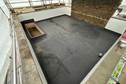 Expert Westminster roofers applying a durable, high-performance single-ply flat roof membrane.