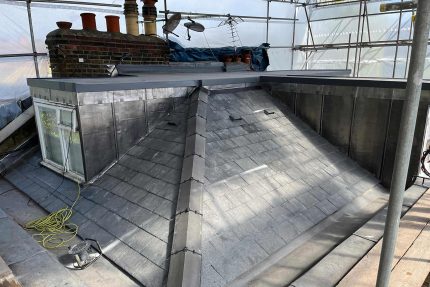 A newly constructed flat roof featuring a glass skylight in Fulham, London.