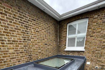 ompleted IKO single ply flat roof featuring newly fitted skylights for natural indoor lighting.