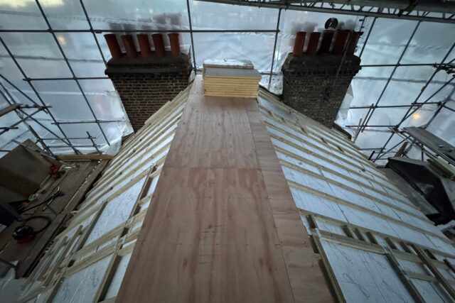 Natural slate roof tiles, skylight flashing, and brick parapet leadwork completed in Notting Hill W11.