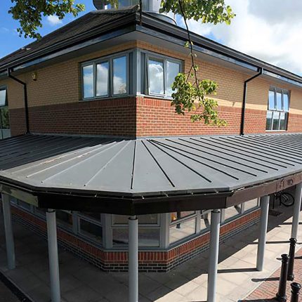 A newly installed flat roof showing clean lead flashing and waterproof sealing on a property in Barnes.
