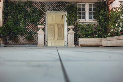 View project details for the Kensington flat roof terrace replacement featuring a preserved glass greenhouse.