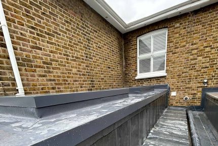 Installing a durable single-ply flat roof system for a Wimbledon residential client.