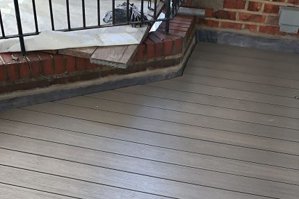Durable composite decking and bespoke iron railings installed on a West Hampstead roof terrace.