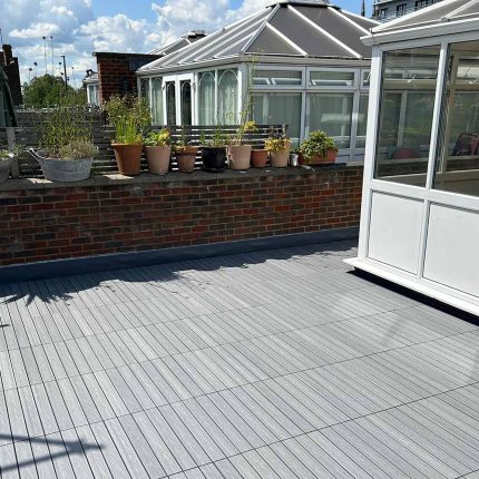 Luxury residential roof terrace transformation in Putney featuring bespoke composite decking and advanced flat roof waterproofing systems.