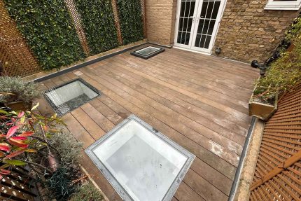 Applying high-performance flat roof insulation beneath reclaimed terrace decking for optimal thermal efficiency.