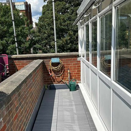 Commercial balcony and grey composite decking reinforcement completed by our experienced roofer london construction crew.