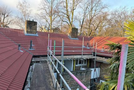 Laying durable Redland concrete tiles to create a classic, weather-resistant pitched roof.
