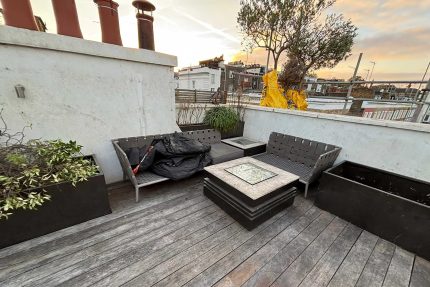Careful removal of old decking to prepare the balcony for structural improvements.