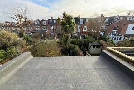 Durable and weather-resistant flat roof completed by Richmond roofing specialists.