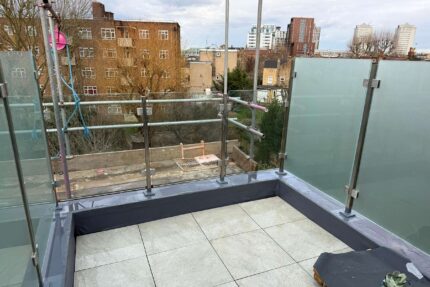 Installing a durable single-ply flat roofing system and paving slabs laid on adjustable pedestals.