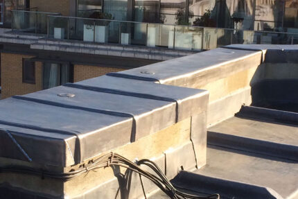 Newly installed lead roof capping developing a natural patina on a high-end Kensington property.