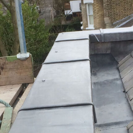 Natural slate roof replacement and lead valley detailing executed by our Hammersmith roofing team.