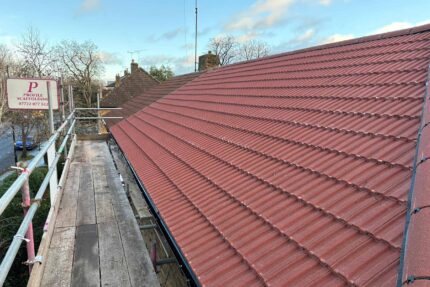 Installing new treated battens and breathable underlay for a pitched roof upgrade.