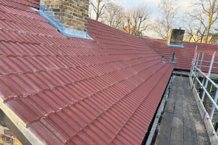 Laying Redland 49 concrete interlocking tiles for exceptional water shedding and durability.