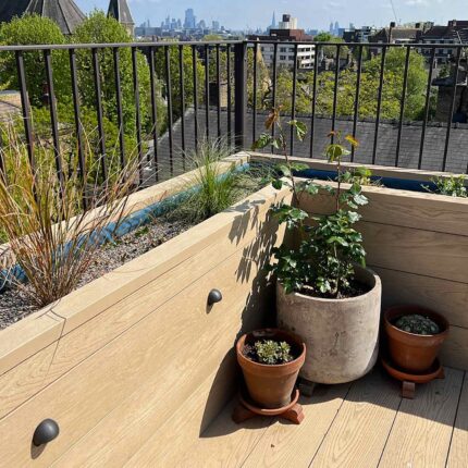 Luxury residential roof terrace transformation in West Hampstead featuring bespoke timber decking and advanced flat roof waterproofing systems.