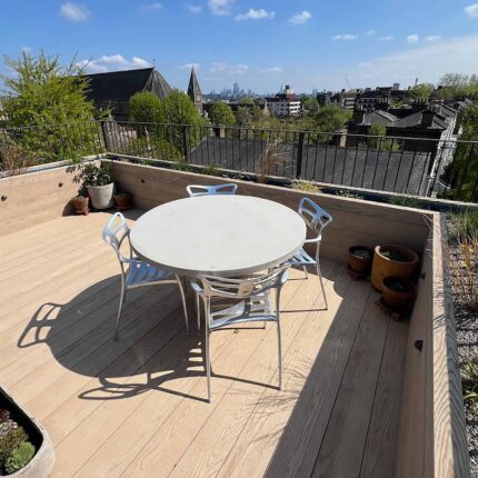 Luxury residential roof terrace transformation in West Hampstead featuring bespoke timber decking and advanced flat roof waterproofing systems.