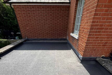 Expertly installing highly durable Debotec Mineral Felt on a London flat roof.
