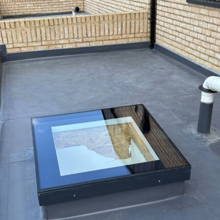 Single-ply flat roof replacement and skylight waterproofing completed by our Hampstead flat roofers.