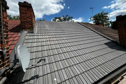 Stripping old roofing materials to inspect rafters before installing new loft insulation.
