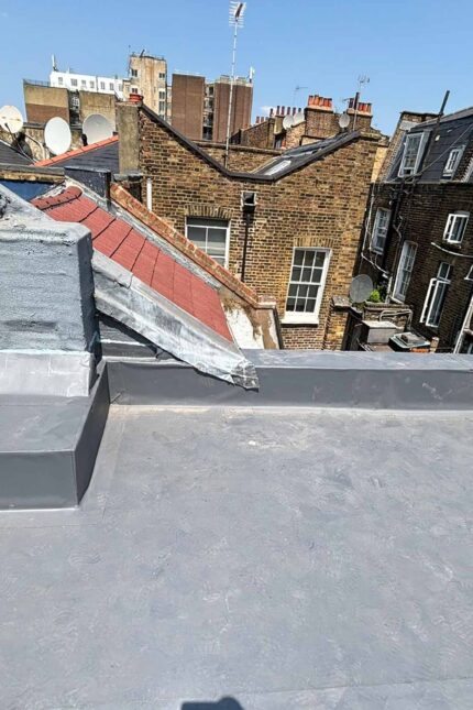 A modern residential property featuring a newly installed flat roofing system.