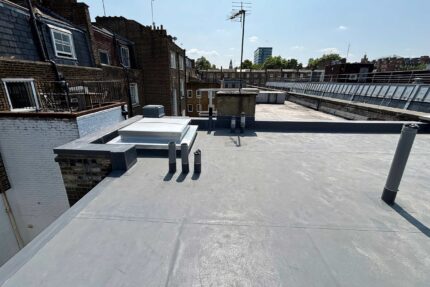 Discreet, low-pitch flat roof restoration completed in the Chelsea urban landscape.