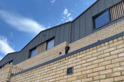 Completed fully insulated warm deck flat roof featuring a seamlessly integrated glass skylight.