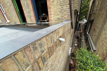 Completed watertight flat roof system with clean edge detailing by West London roofing contractors.
