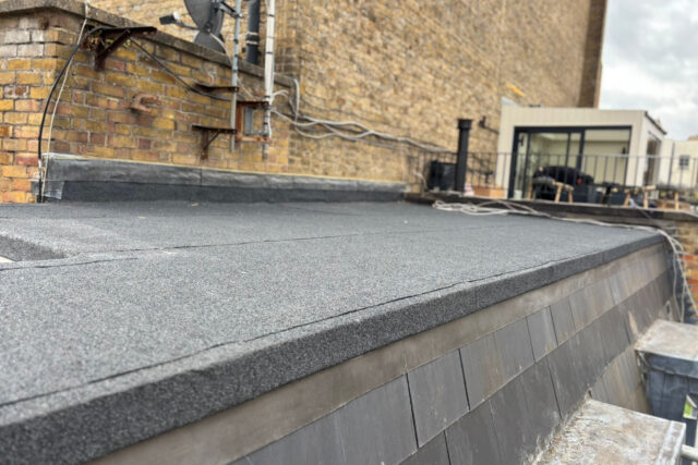 High-end charcoal mineral felt membrane applied to a reinforced structural deck, showcasing flawless domestic waterproofing by our expert London roofing team.
