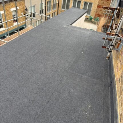 Multi-layer flat roof bitumen membrane bonded securely to structural decking, a premium residential solution delivered by our skilled London roofing installers.